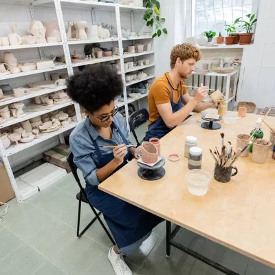 depositphotos_614417882-stock-photo-multiethnic-couple-aprons-painting-ceramic